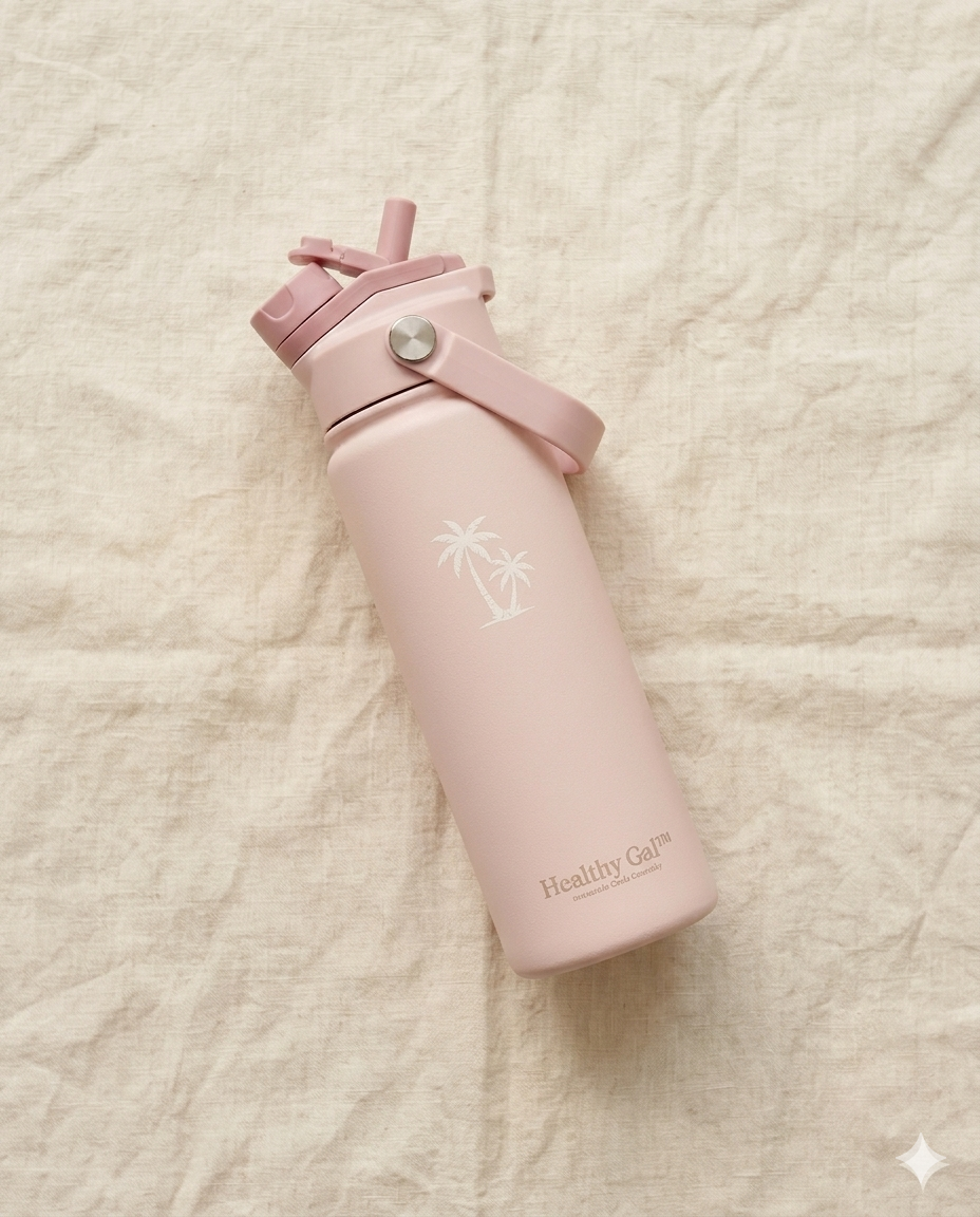 Healthy Gal™ Move Hydration Bottle in blush pink lying on a white linen surface, flat lay view showing the palm tree logo