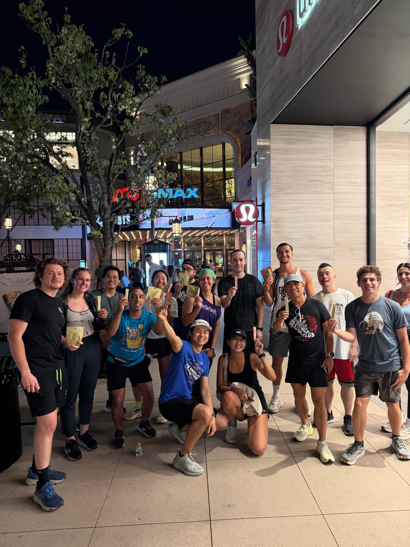 Healthy Gal community group photo outside at a nighttime run event